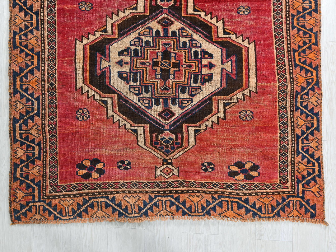 a red rug with an intricate design on it