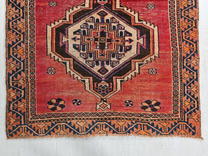 a red rug with an intricate design on it