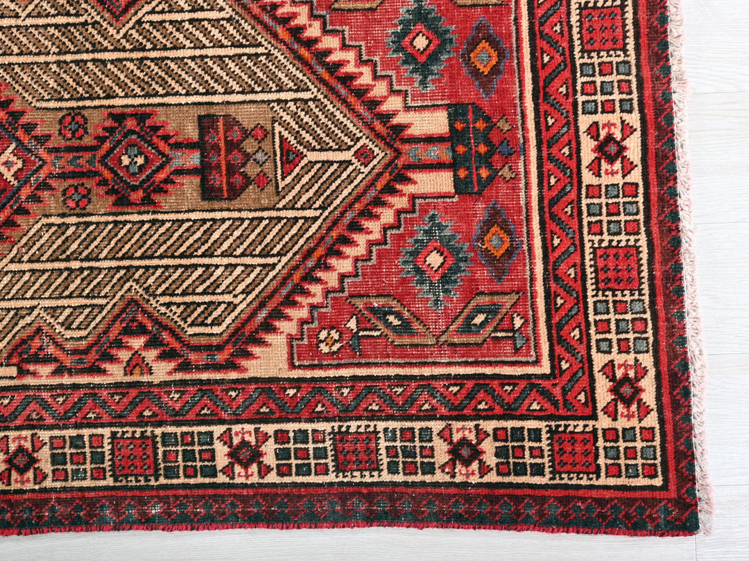 a red and black rug with a design on it