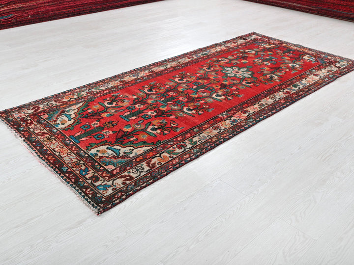 a red oriental rug on a white floor
