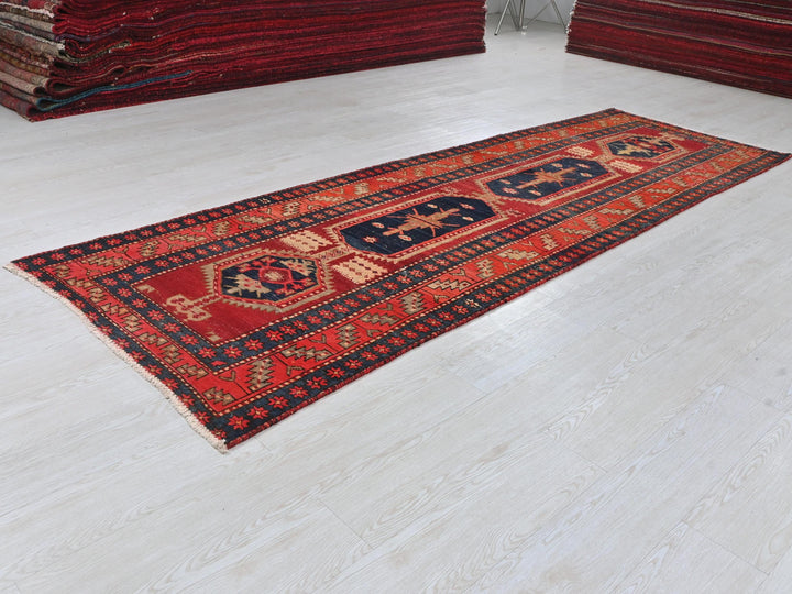 a pile of red rugs sitting on top of a white floor