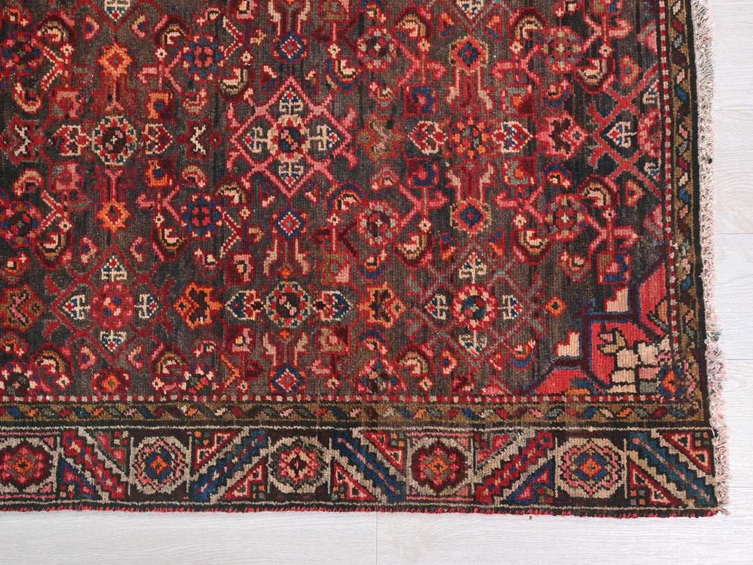a red and blue rug on a white floor
