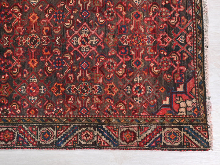 a red and blue rug on a white floor