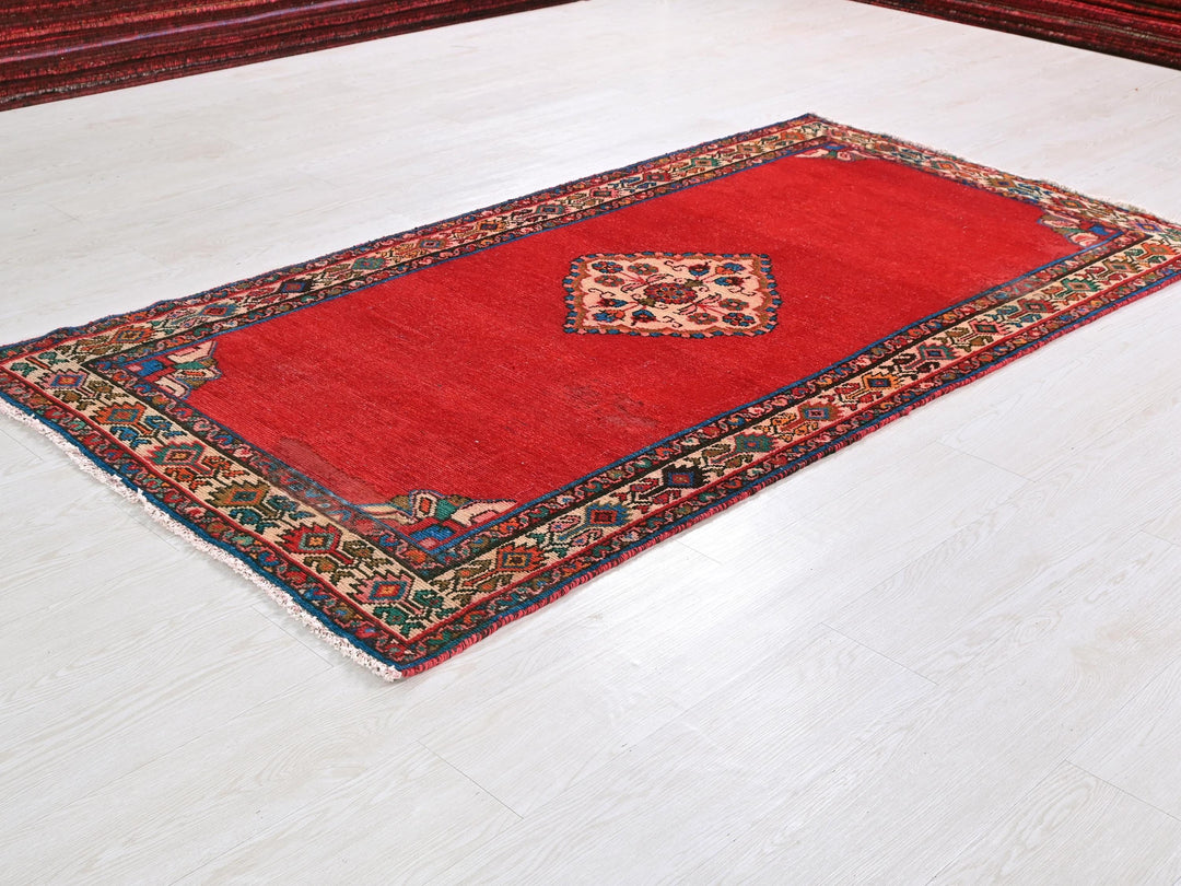 a red rug on a white floor with a leopard print on it
