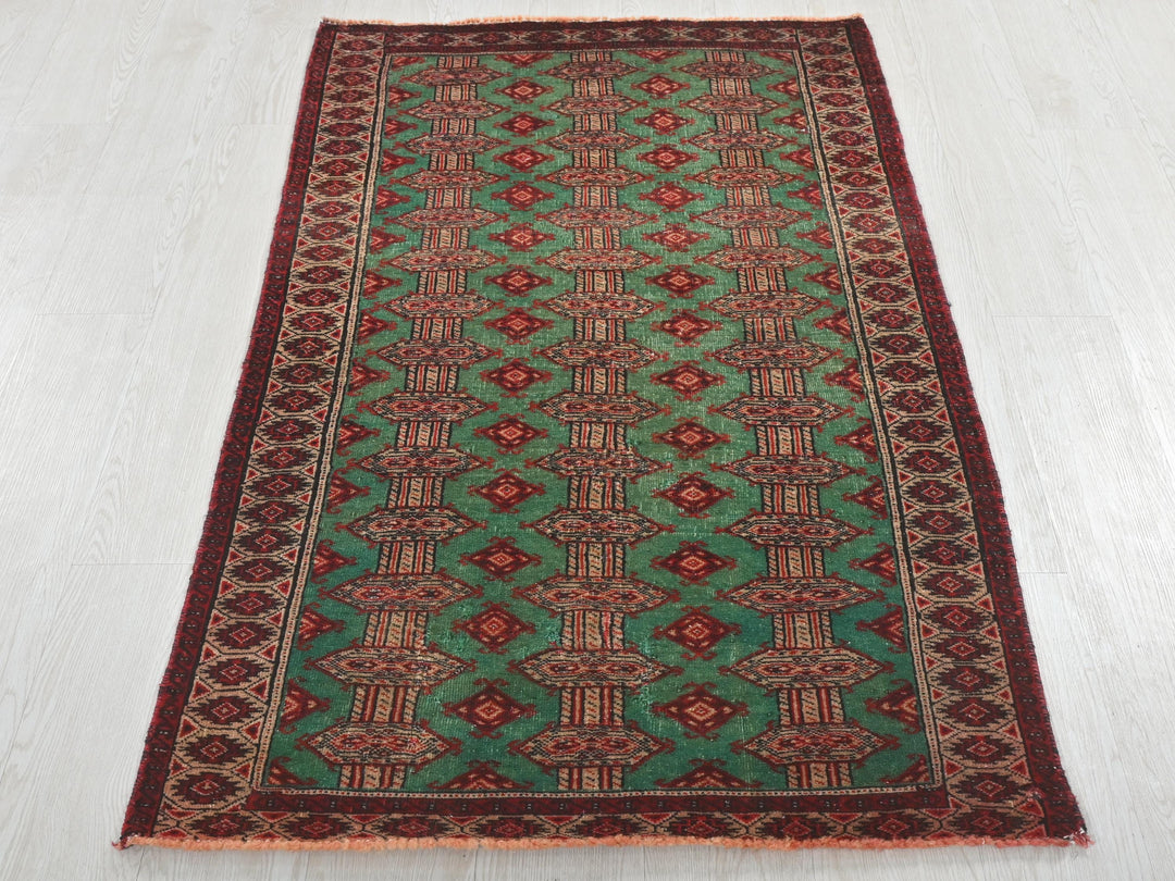 a green and red rug on a white floor