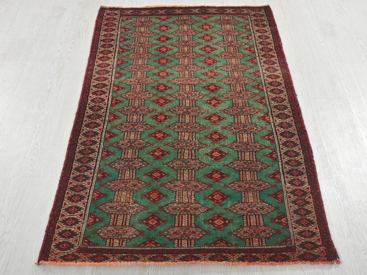 a green and red rug on a white floor