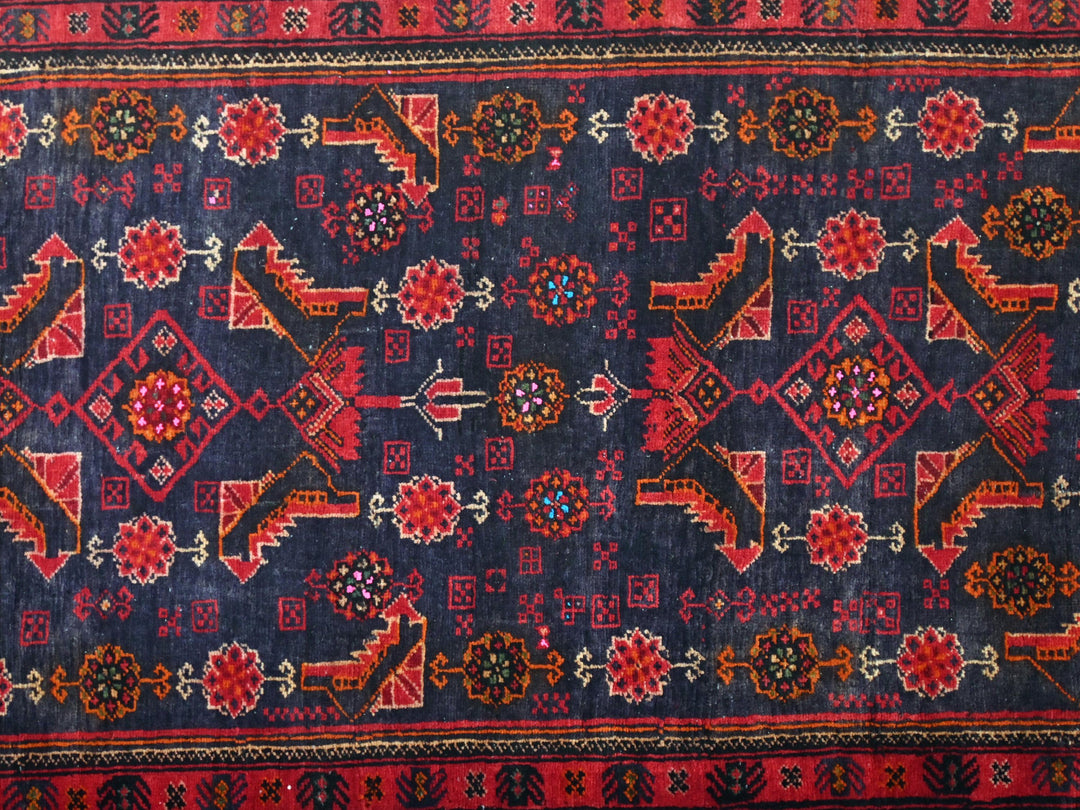 a blue and red rug with a design on it