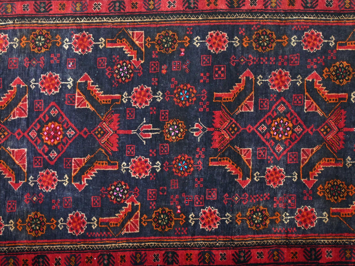 a blue and red rug with a design on it