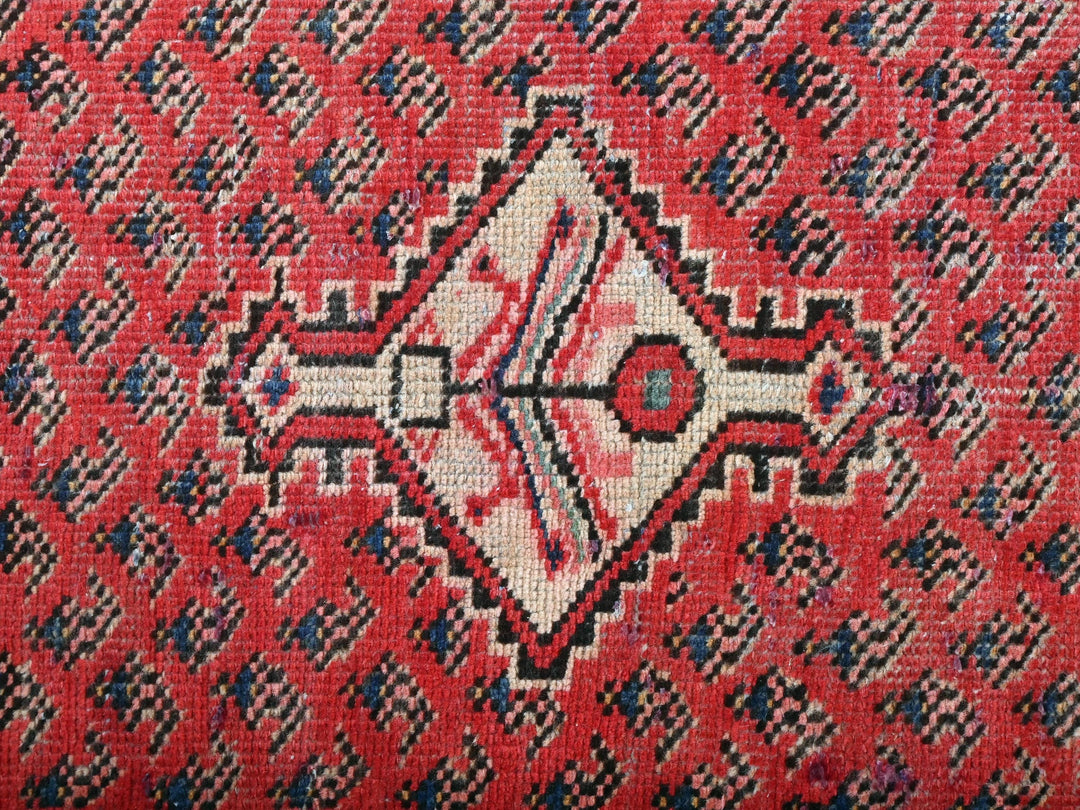 a close up of a red and black rug