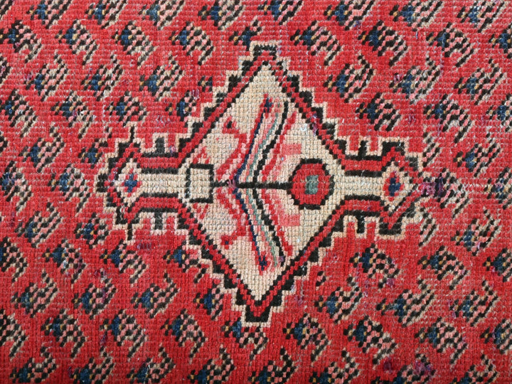 a close up of a red and black rug
