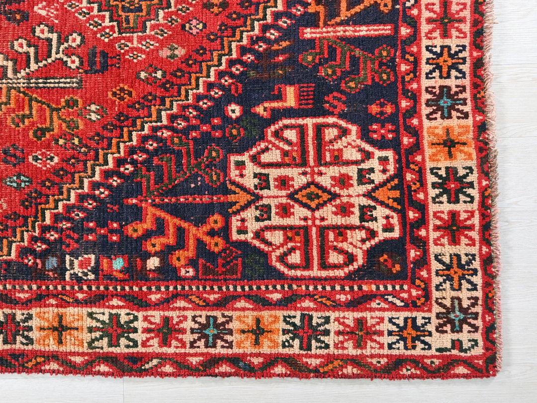 a red rug with a colorful design on it
