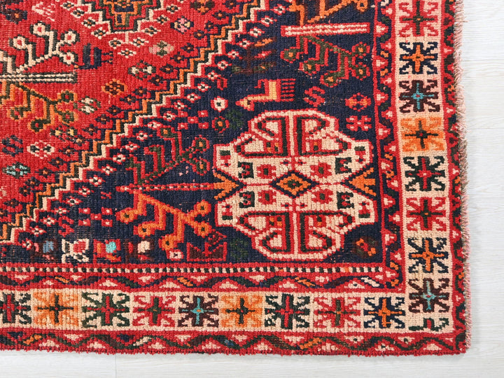 a red rug with a colorful design on it