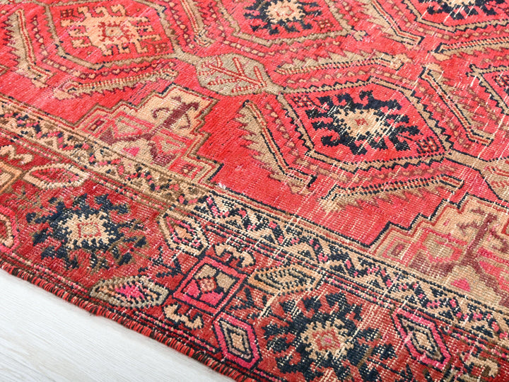 a red rug with a blue and red design on it