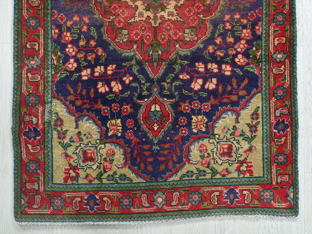 a red and blue rug on a white floor