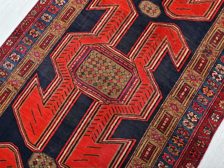 a red and blue oriental rug on a white floor