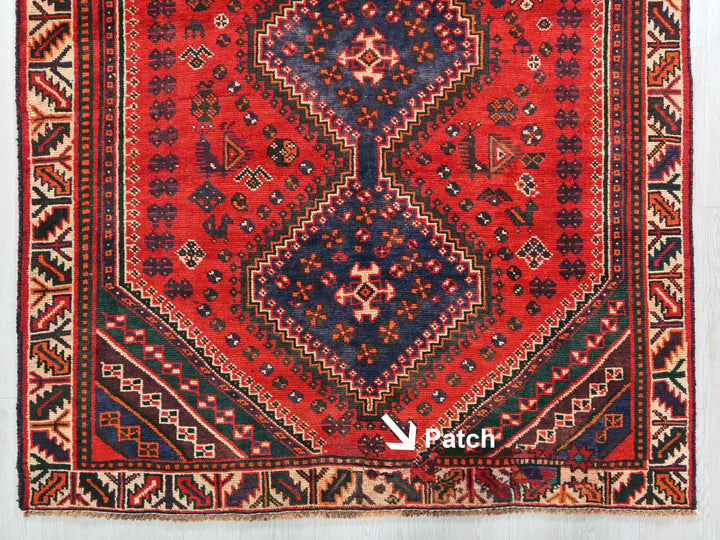 a red rug with a blue and red design