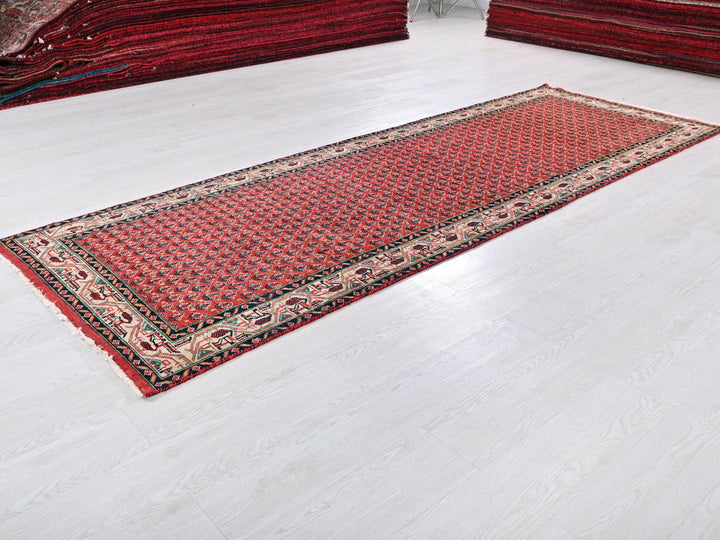 a red rug is laying on a white floor