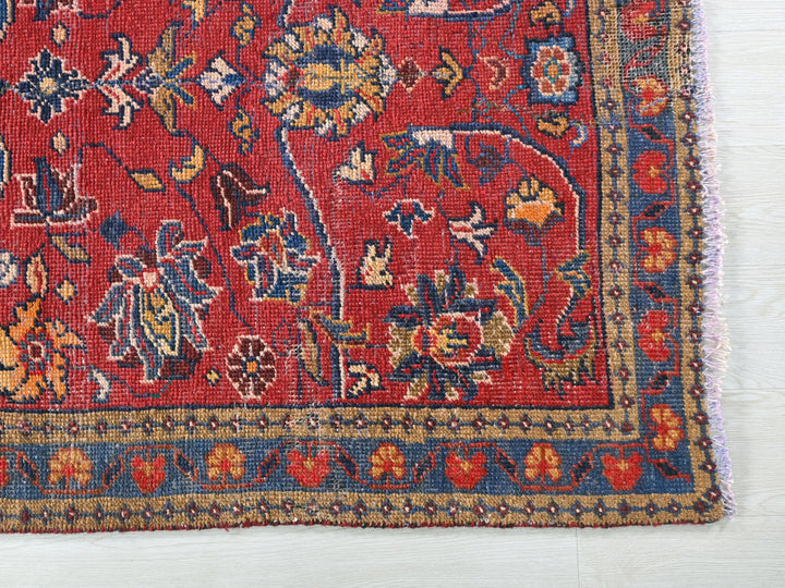 a red rug with a floral design on it