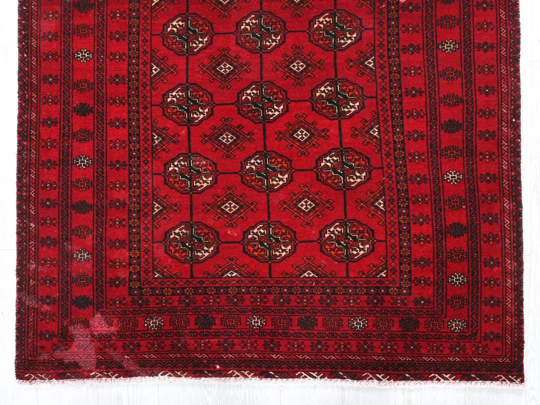 a red rug with a design on it