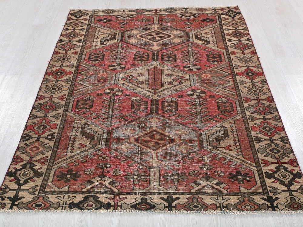 a red and black oriental rug on a white floor