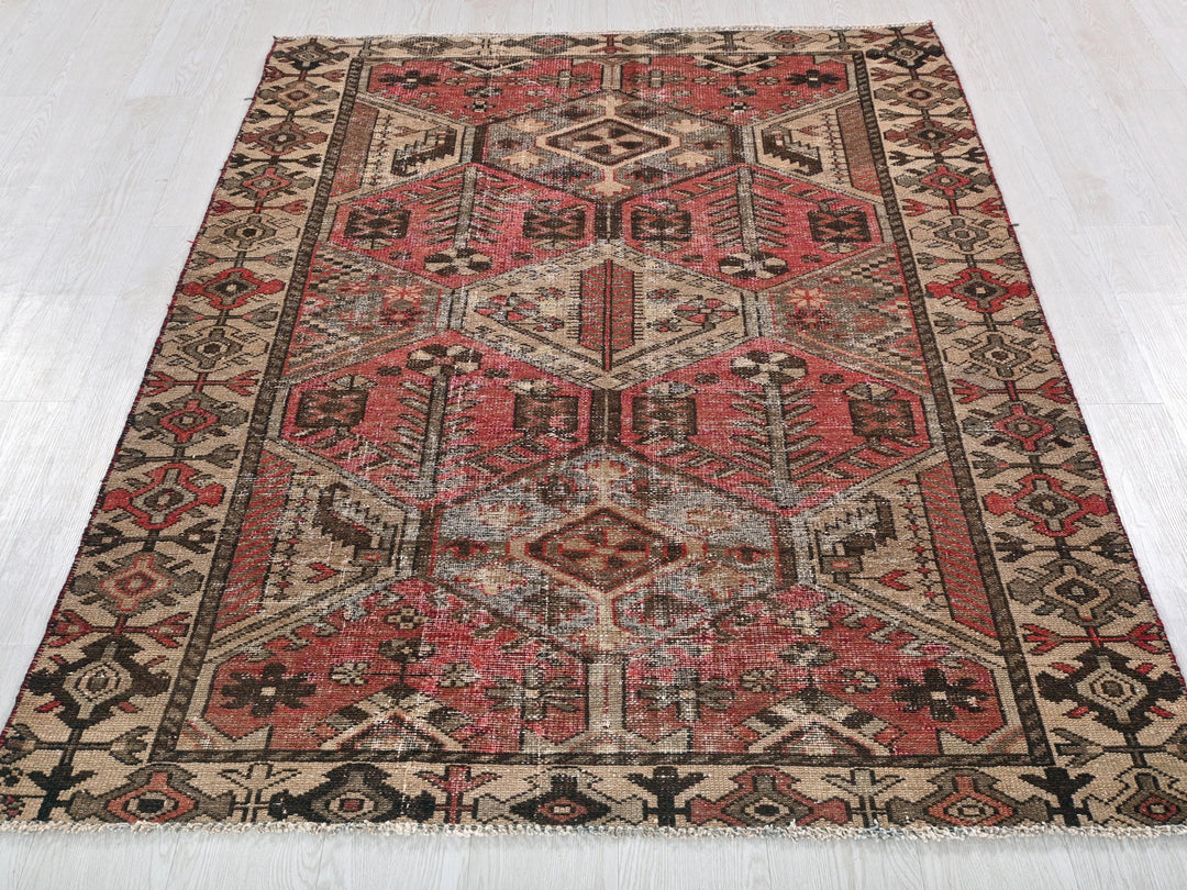 a red and black oriental rug on a white floor