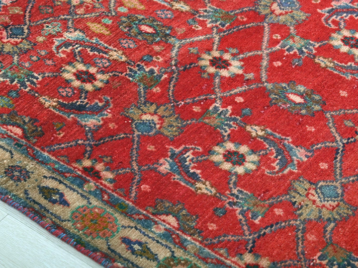 a red rug with a floral design on it