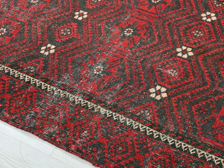 a close up of a red and black oriental rug