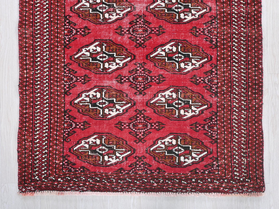 a red rug with a design on it