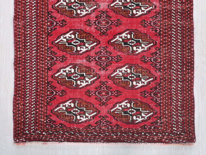 a red rug with a design on it