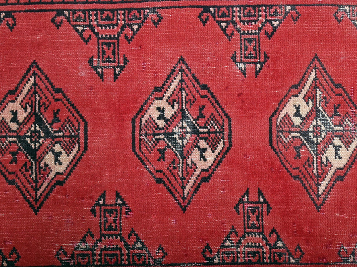 a close up of a rug with a red background