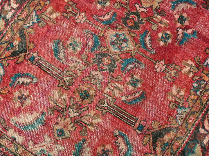 a red rug with a floral design on it