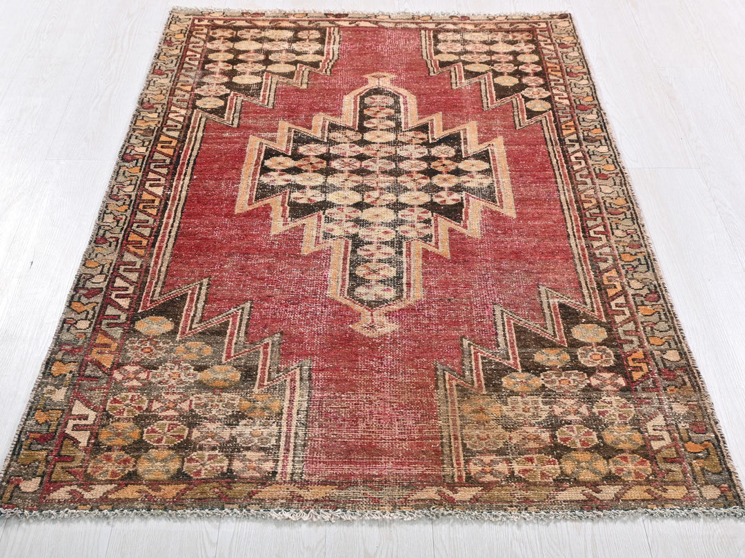a red rug with a cross on the middle of it
