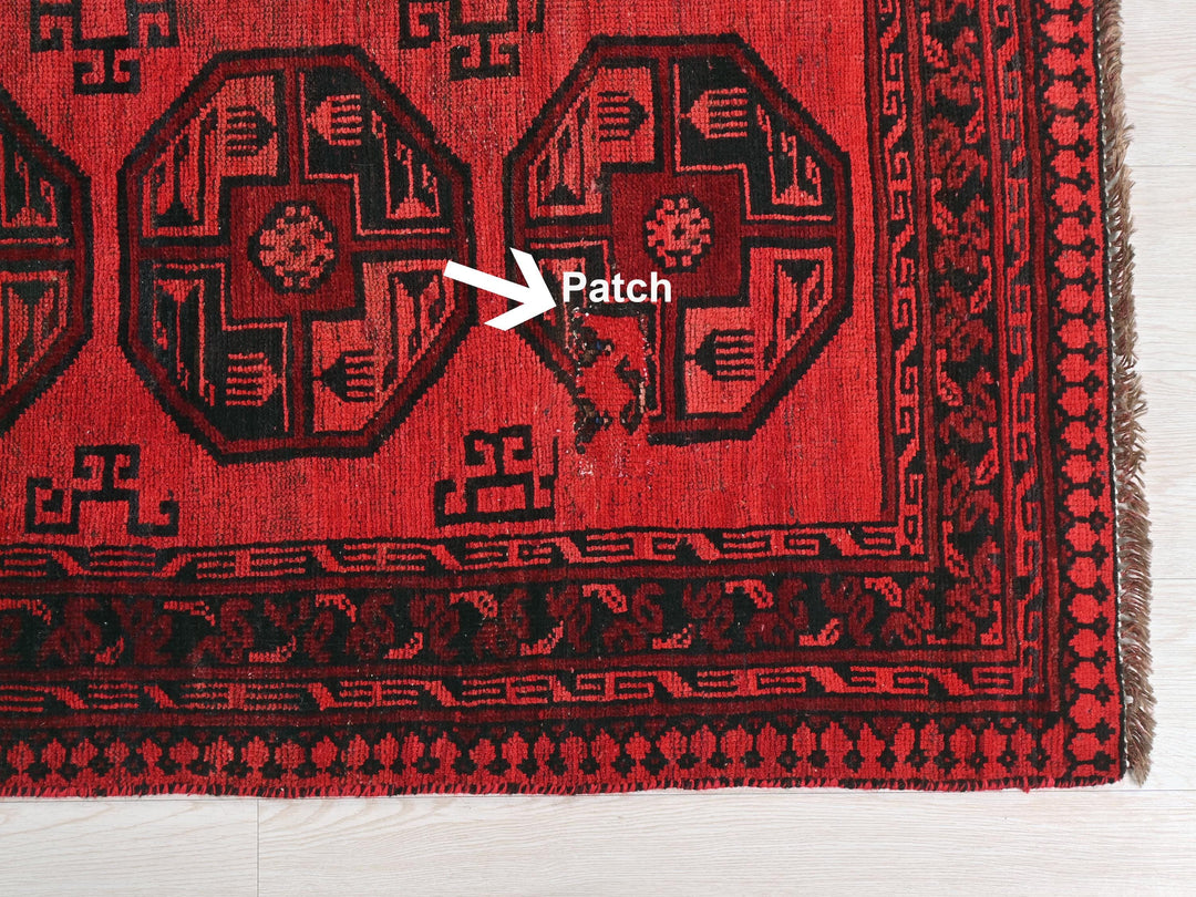 a close up of a rug with a patch on it