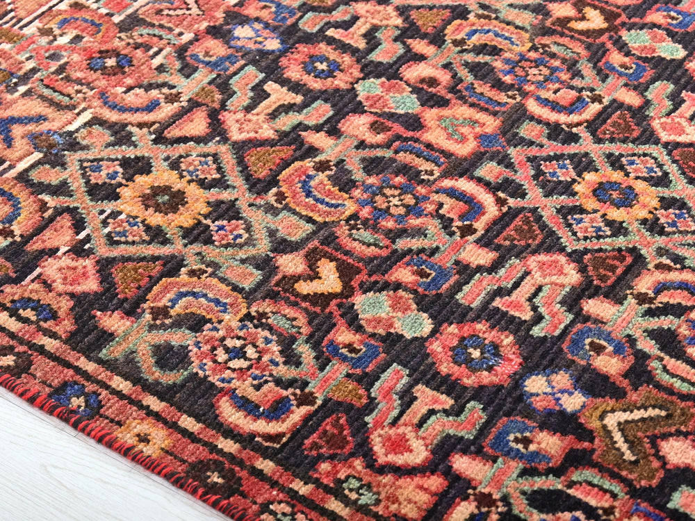 a colorful oriental rug with a wooden floor