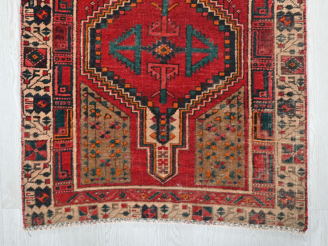 a red rug with a design on it
