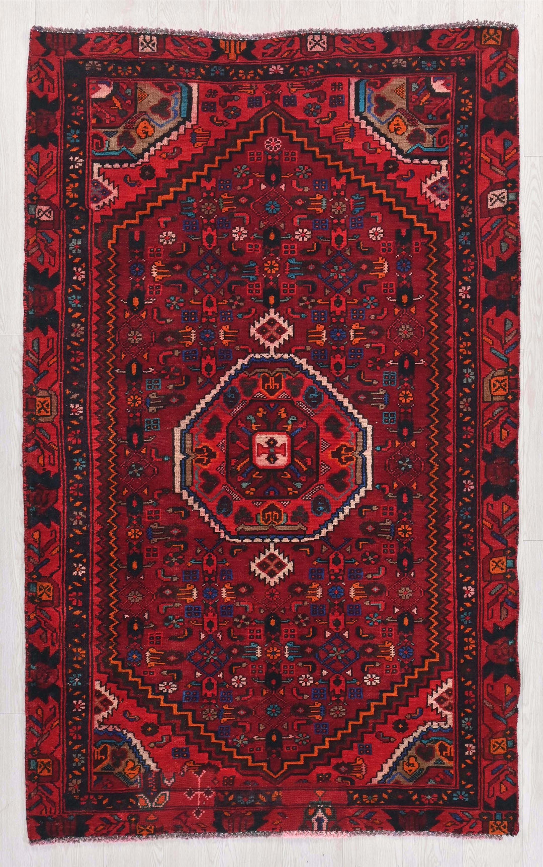 a red rug with a diamond design on it