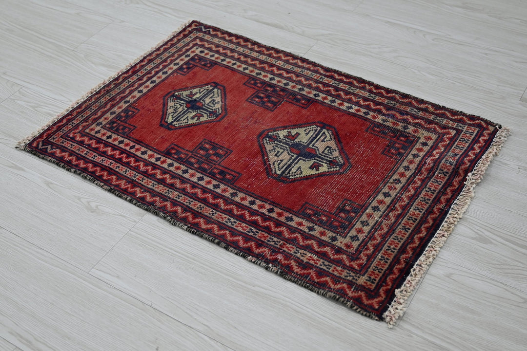 red Accent rug 1' 8" x 2' 5"