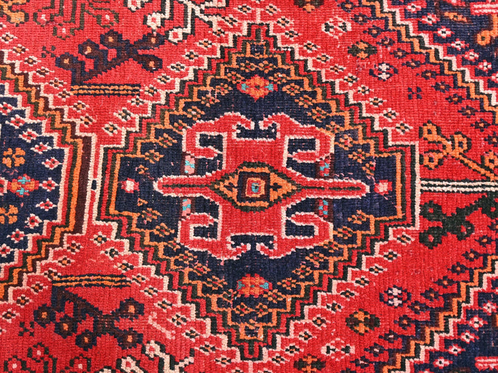 a close up of a rug with a red and blue design