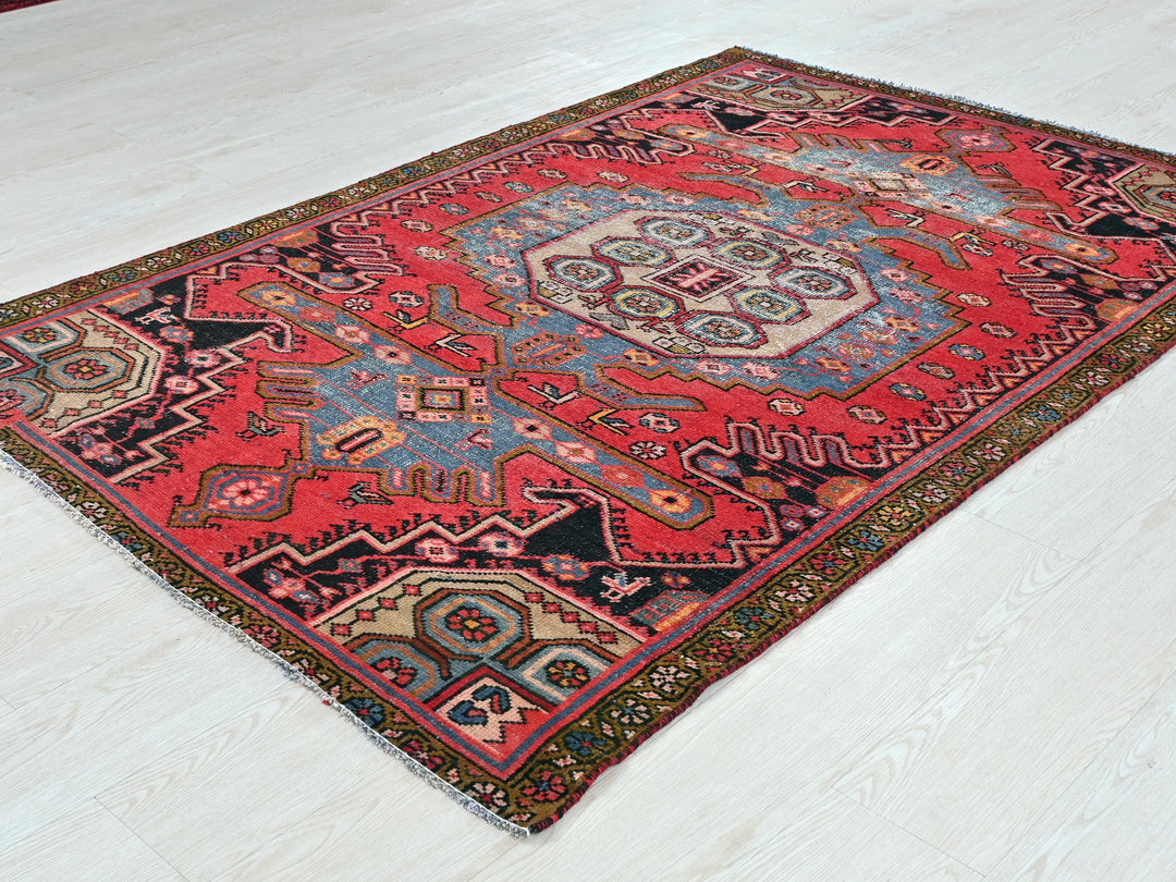 a red and blue rug on a white floor