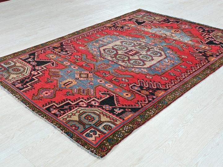 a red and blue rug on a white floor