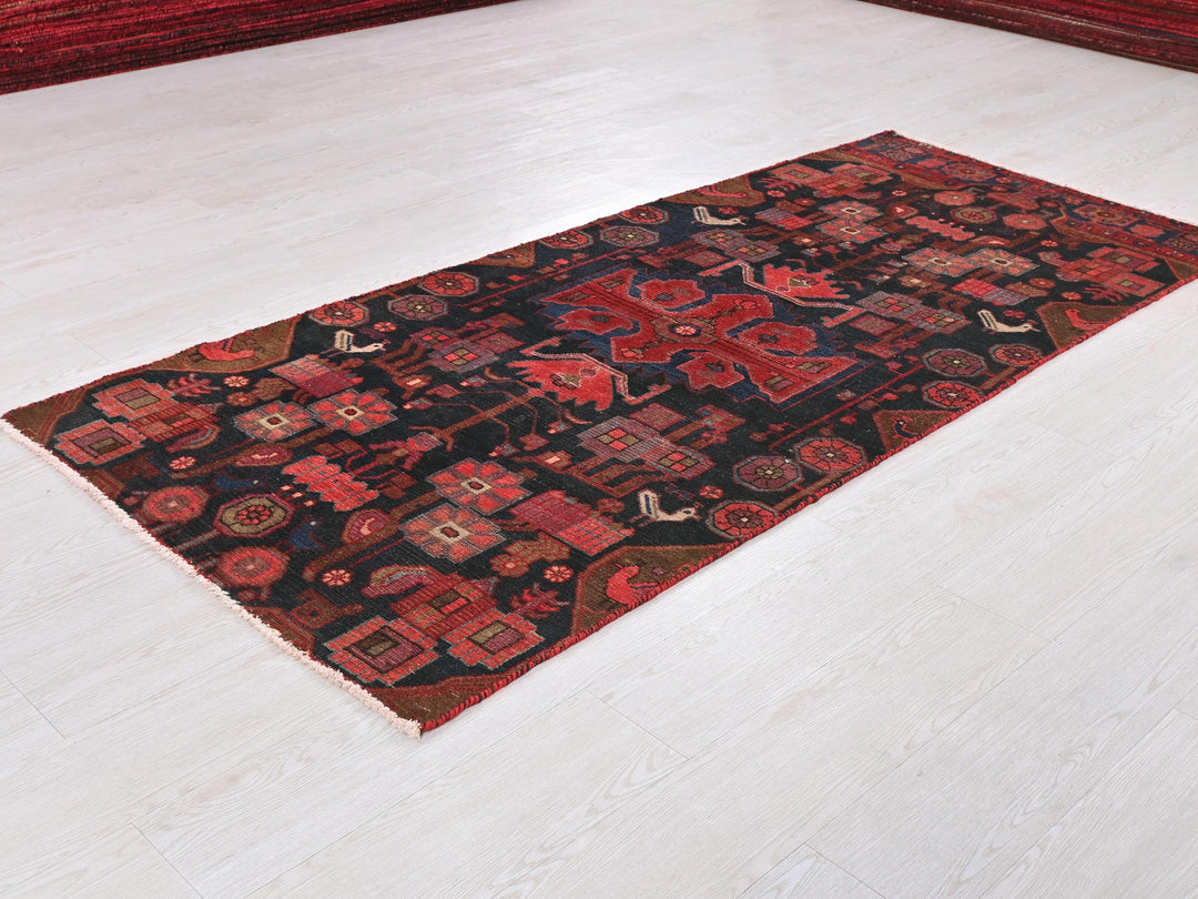 a red and black rug on a white floor