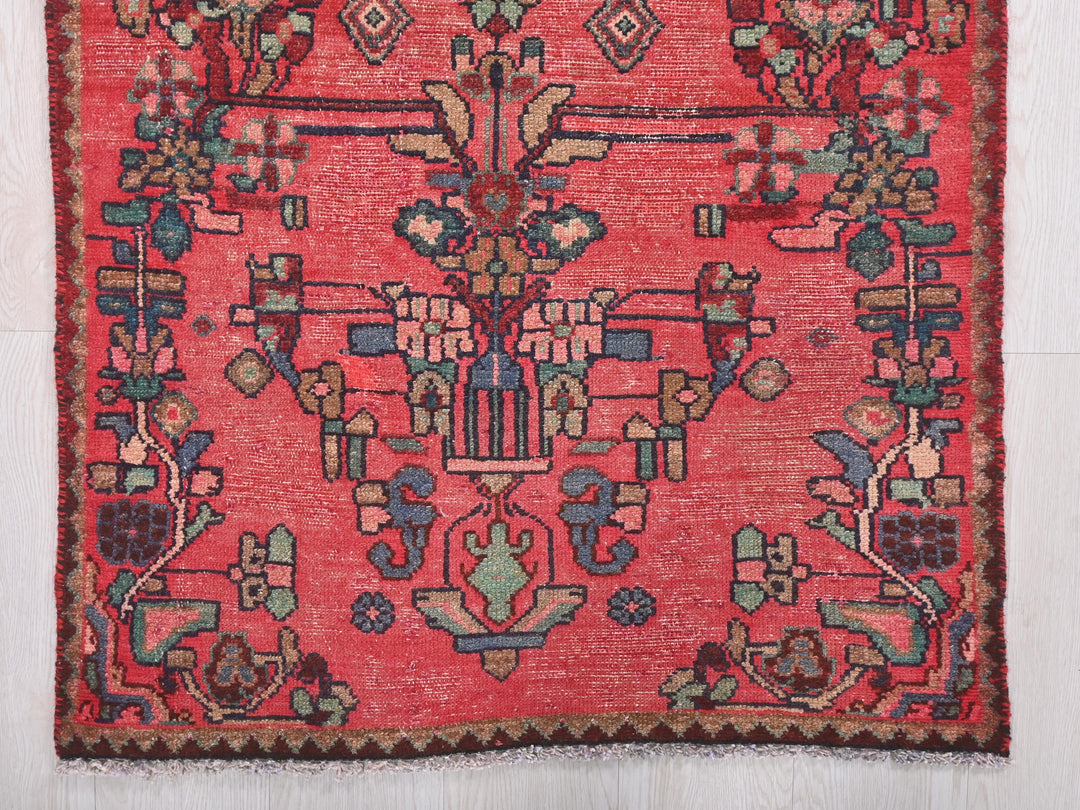 a red rug with a floral design on it