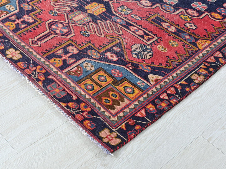 a colorful oriental rug on a white wooden floor