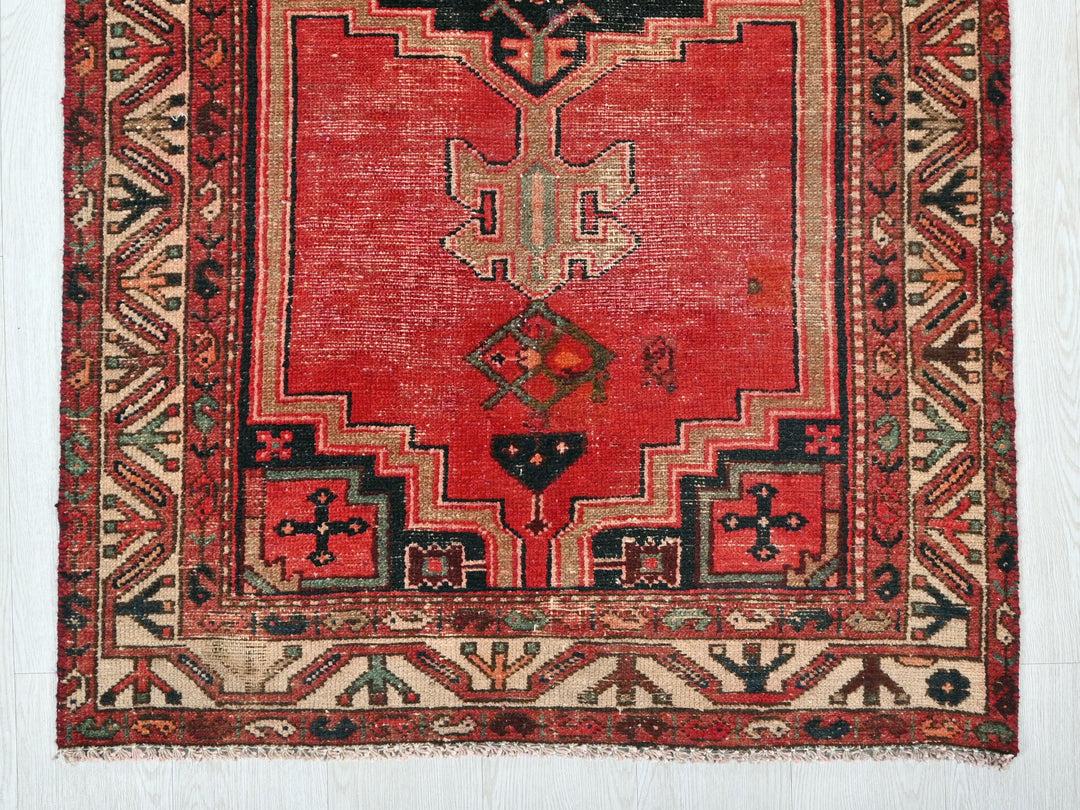 a red rug with a design on it