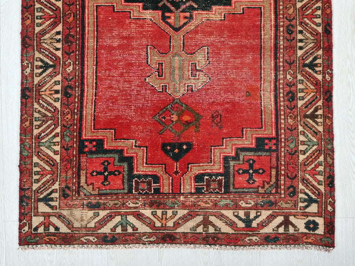a red rug with a design on it