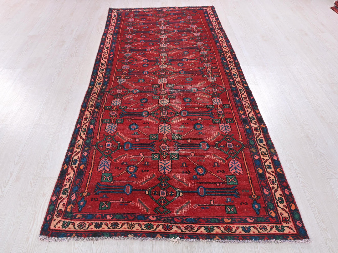 a long red rug on a white floor