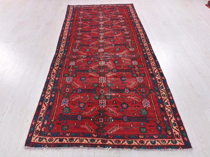 a long red rug on a white floor
