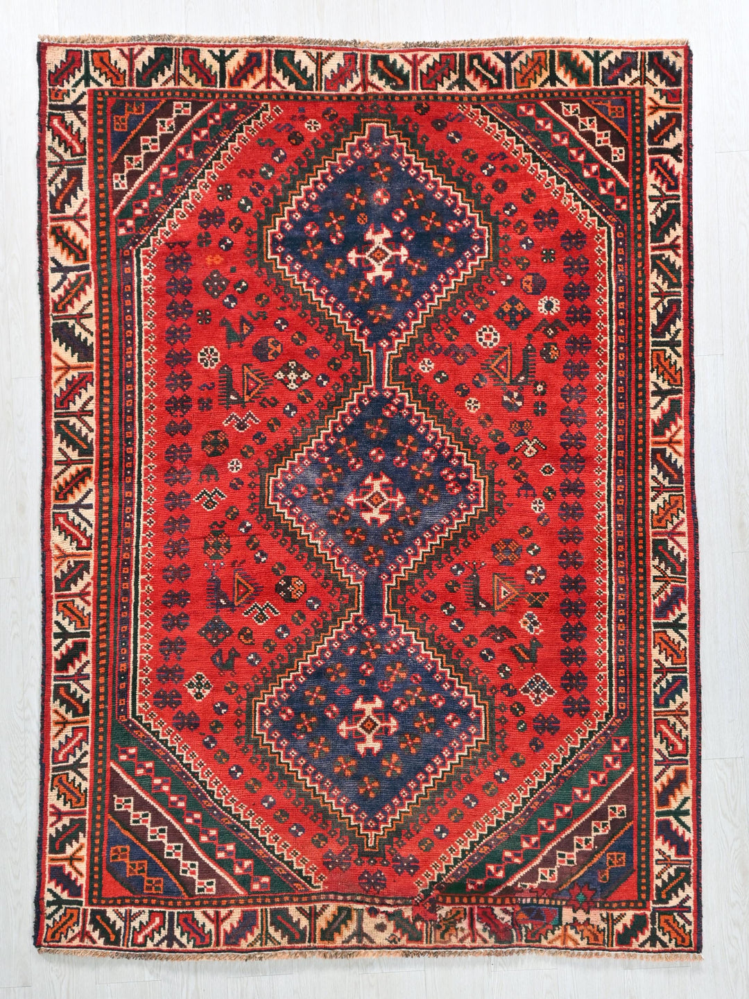 a red and blue rug with a diamond design