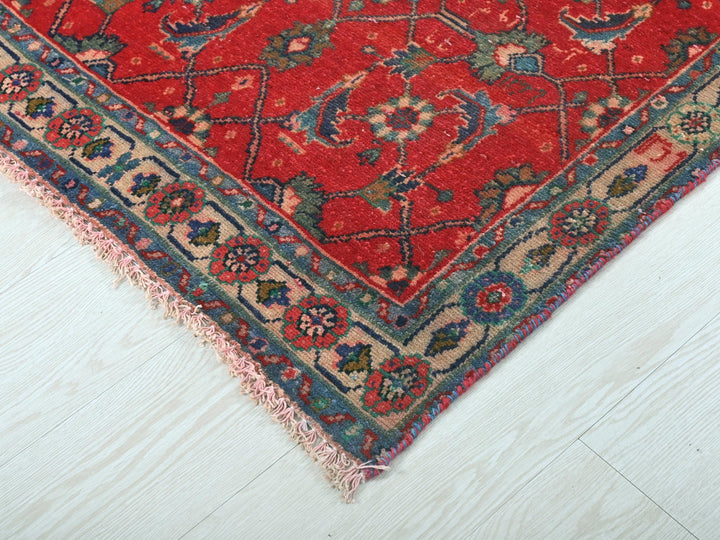 a red rug on a white wooden floor