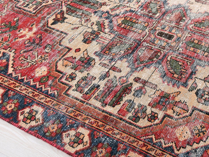 a red and blue oriental rug on a wooden floor